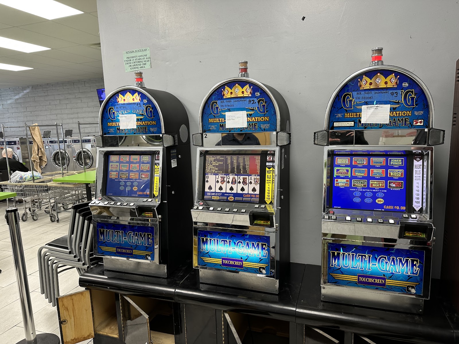 Three Multi-Game touchscreen gaming machines against a gray wall